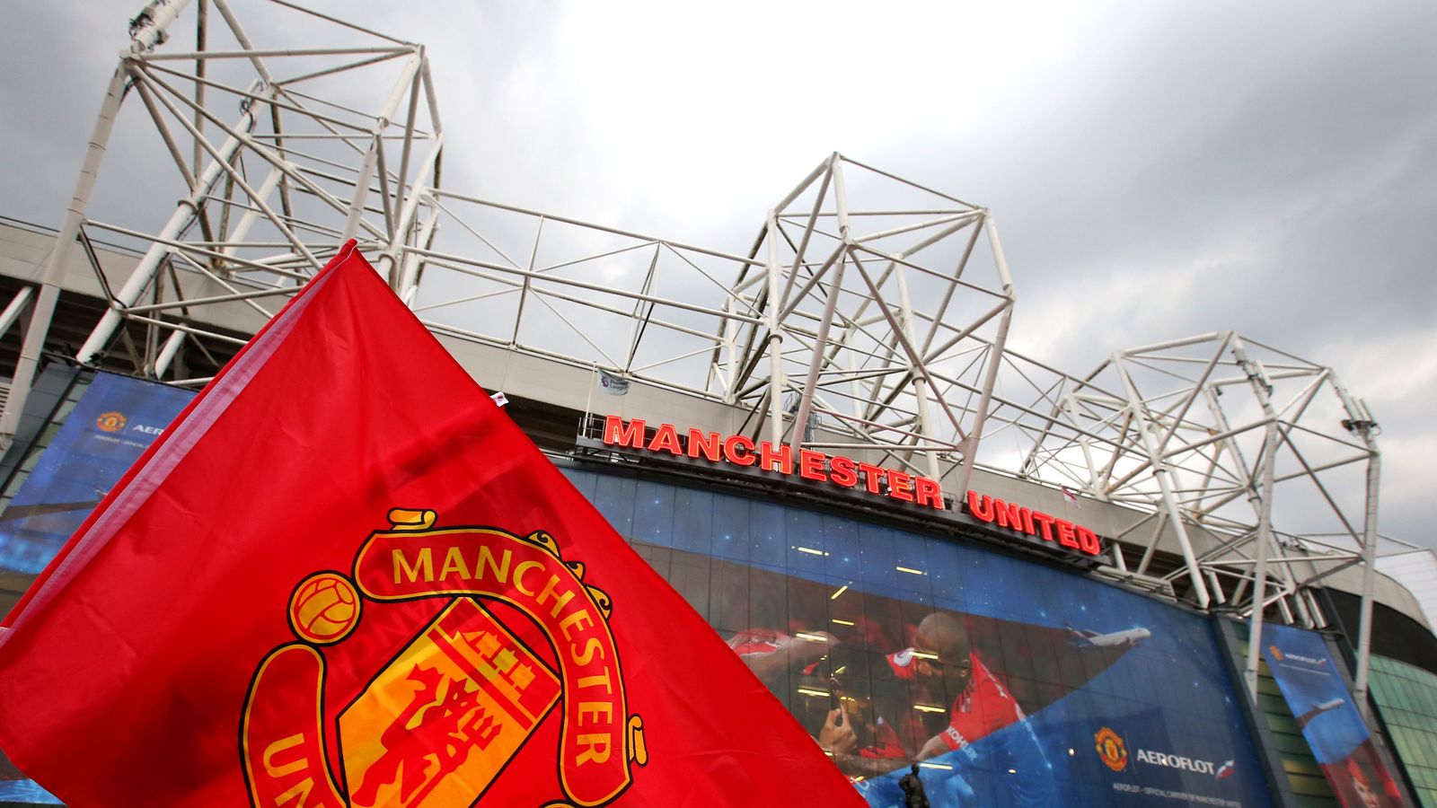 Manchester United flag in front of Old Trafford